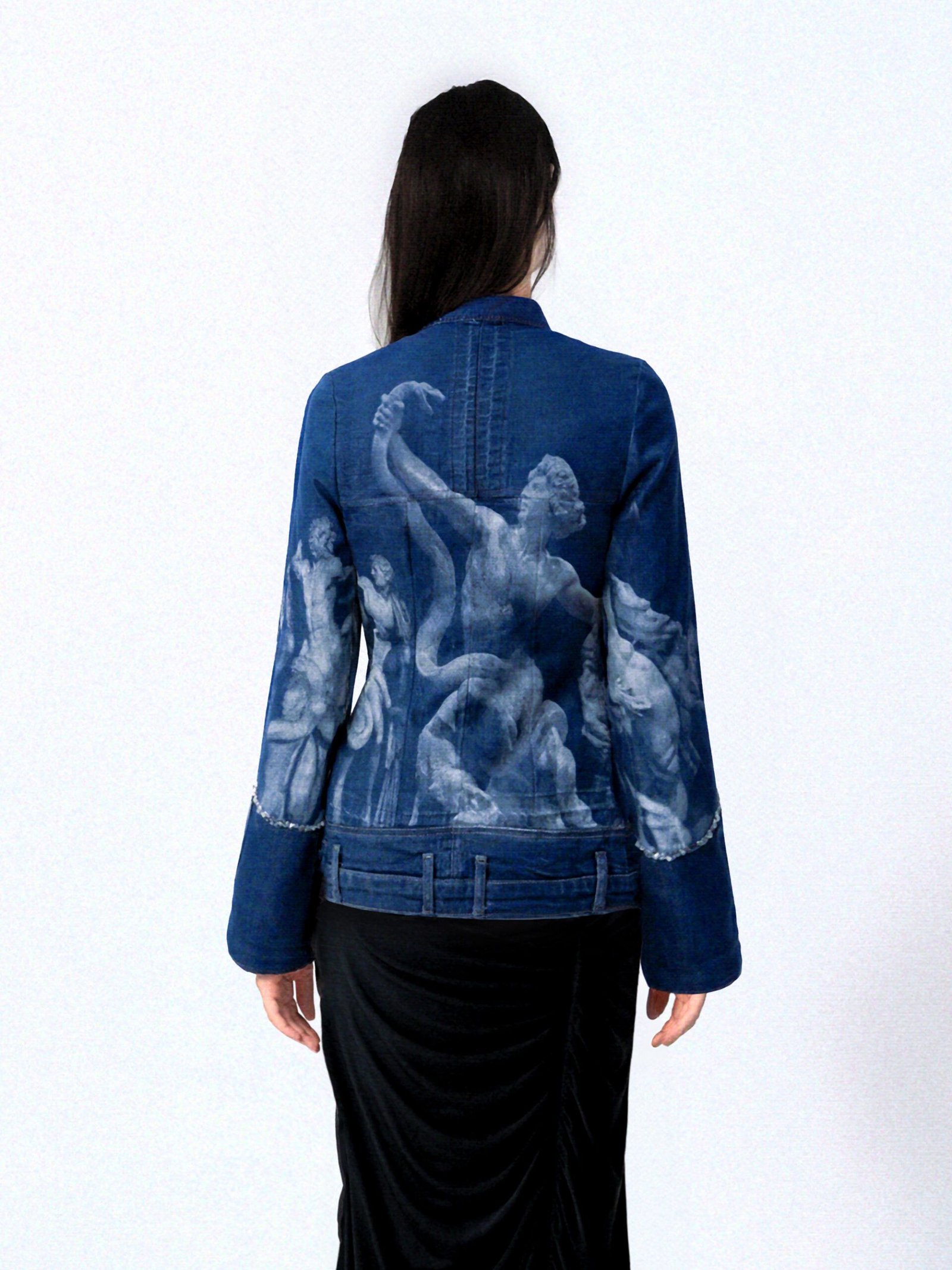 Model in studio photoshoot setting wearing a blue Denim Upcycled Jacket laser etched Greek statue print. editorial high-fashion image.